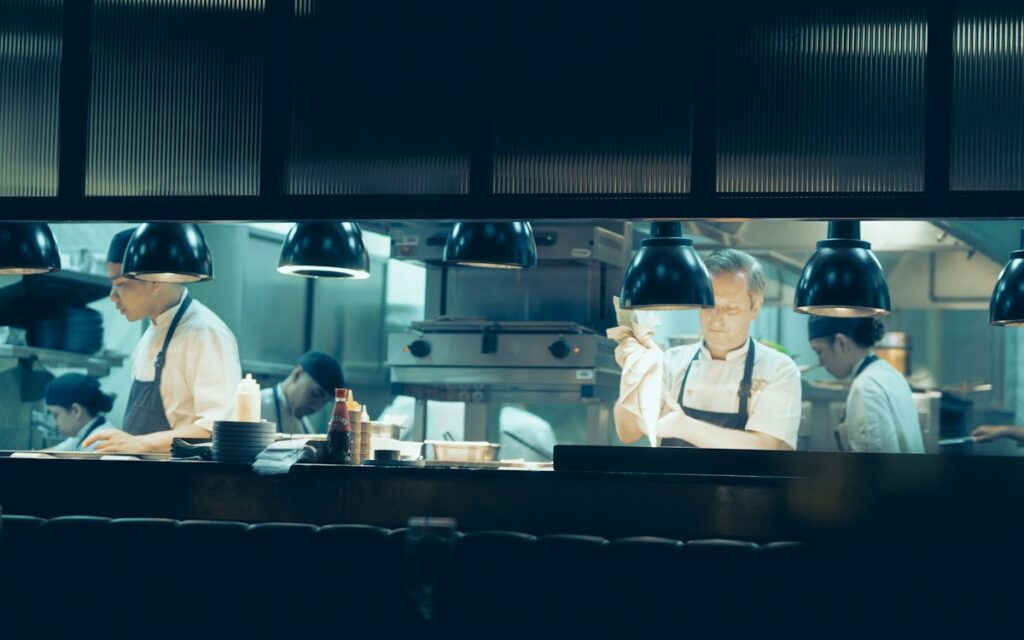 Busy open restaurant kitchen with chefs at work