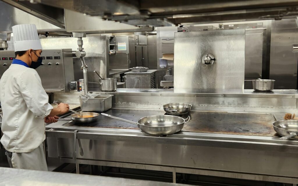 Chef working at a stainless steel counter