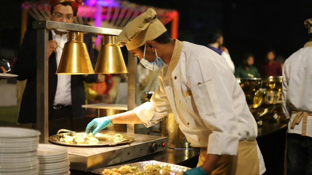 Chefs working at the pass in a hotel kitchen