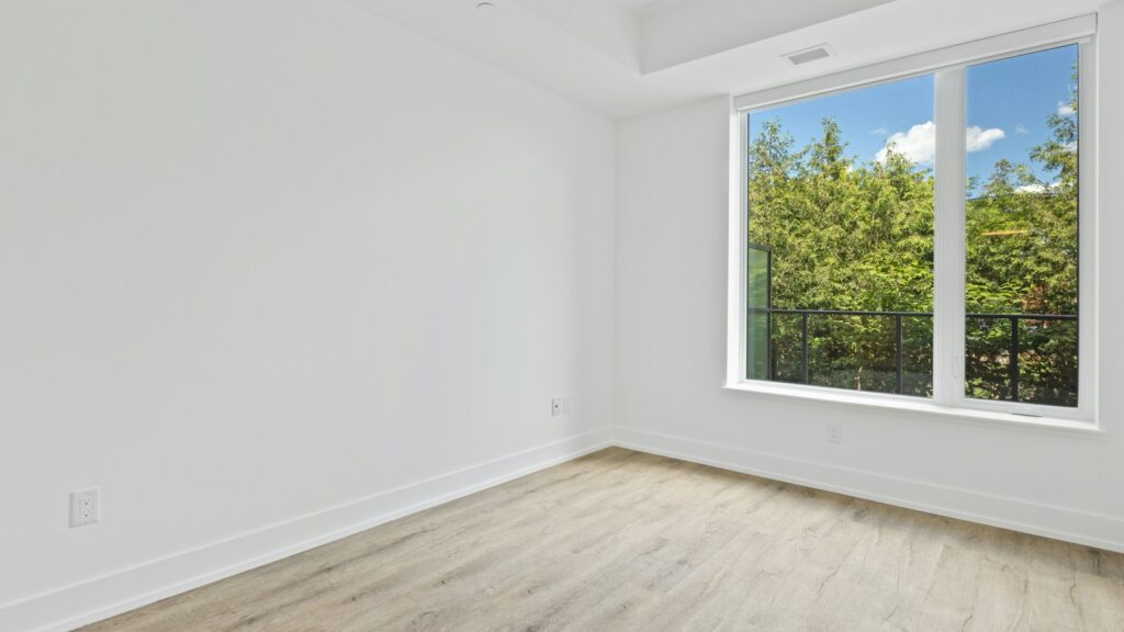 Empty room with a large window during a void period