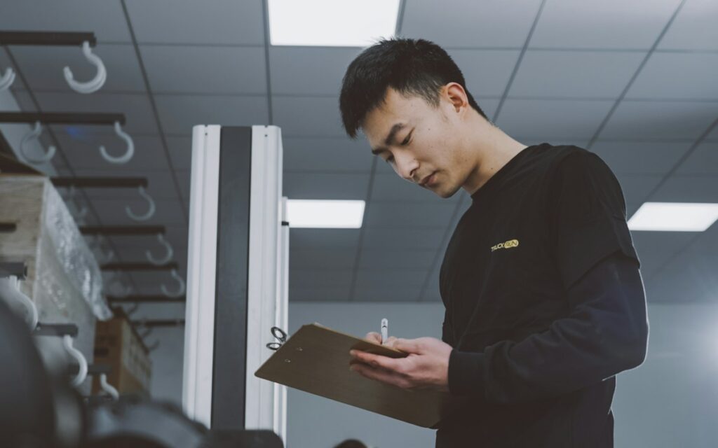 Man inspecting a property and taking notes on a clipboard
