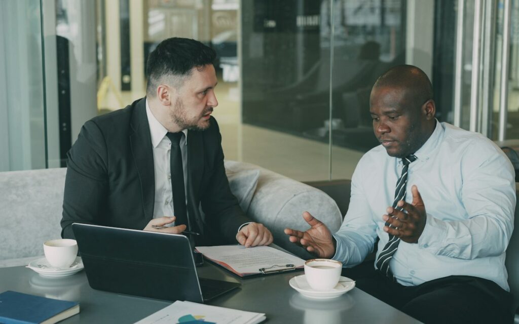 Two people in a business meeting discussing a contract