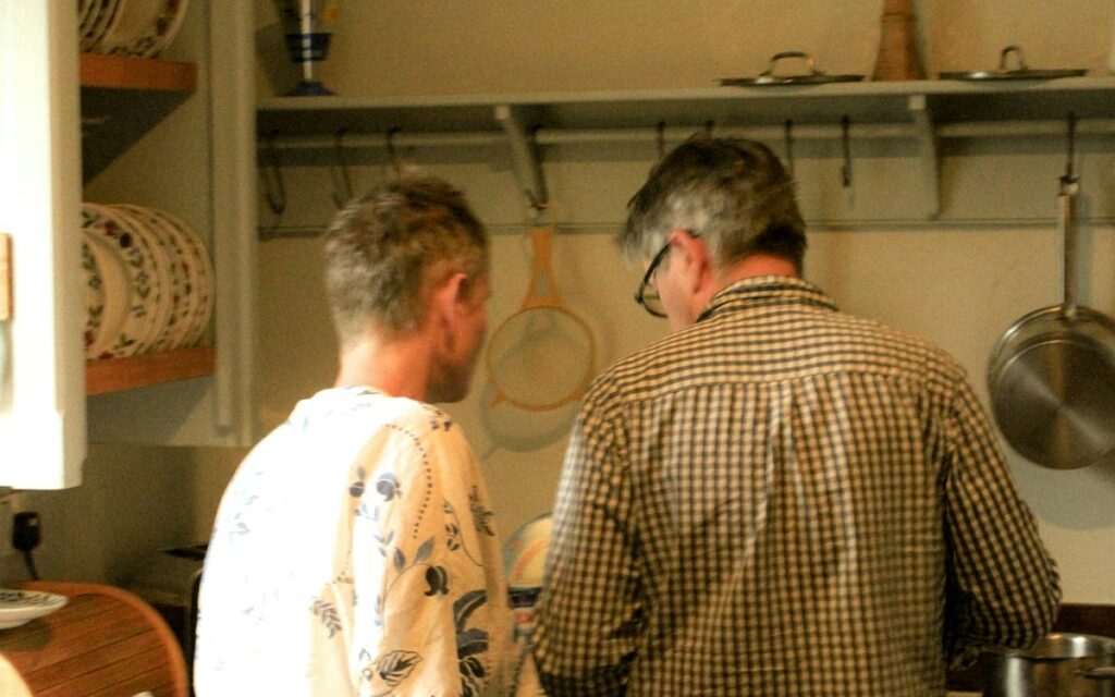 Two housemates cooking in a shared kitchen