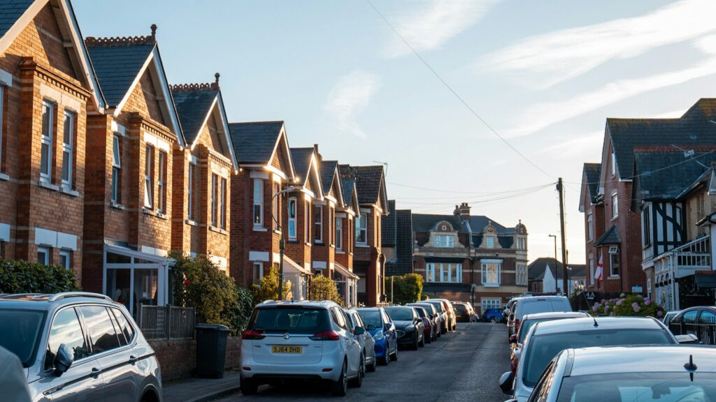 Street of UK terraced houses with parked cars