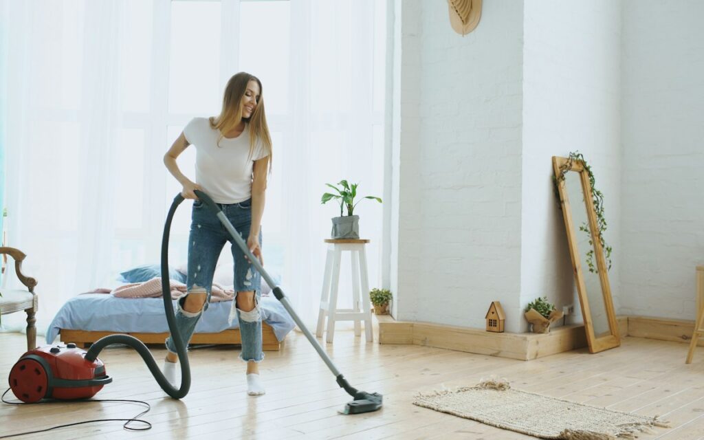 Cleaner vacuuming a bright room